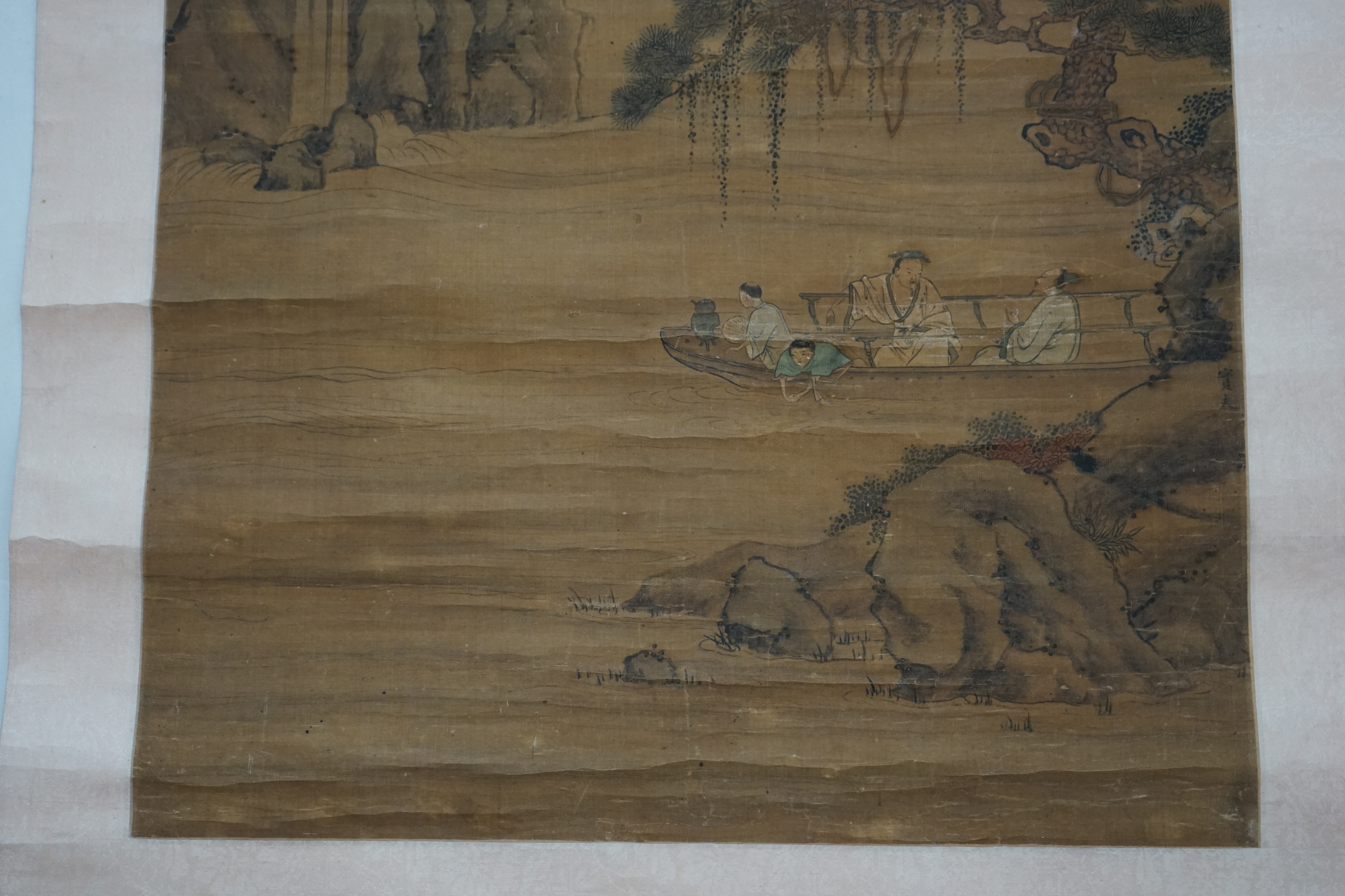 Chinese School, 18th century, a scroll painting on silk of figures on a boat, signed Qiu Ying